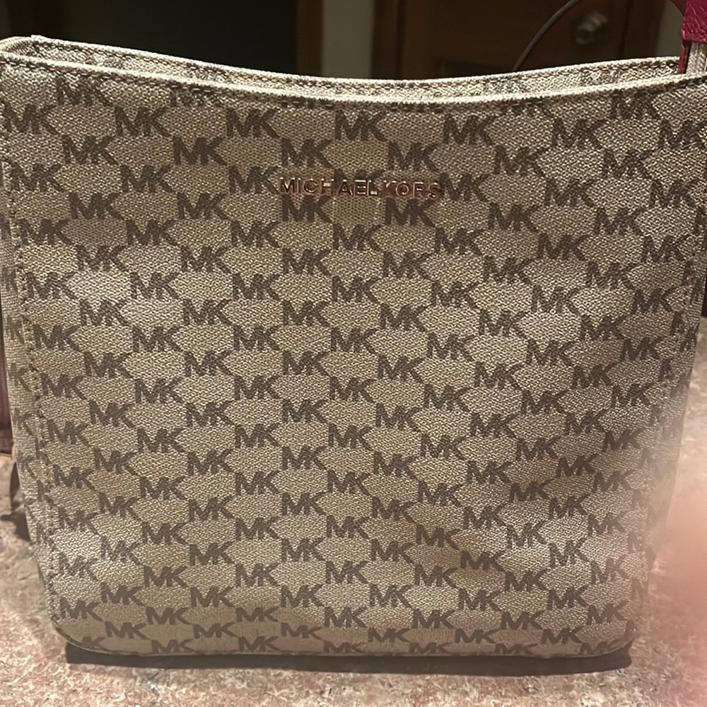 Michael Kors Tan Crossbody with maroon straps.